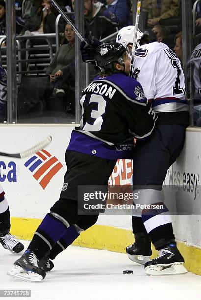 Jack Johnson of the Los Angeles Kings lays a check onto Trevor Linden of the Vancouver Canucks during the NHL game at Staples Center on March 29,...