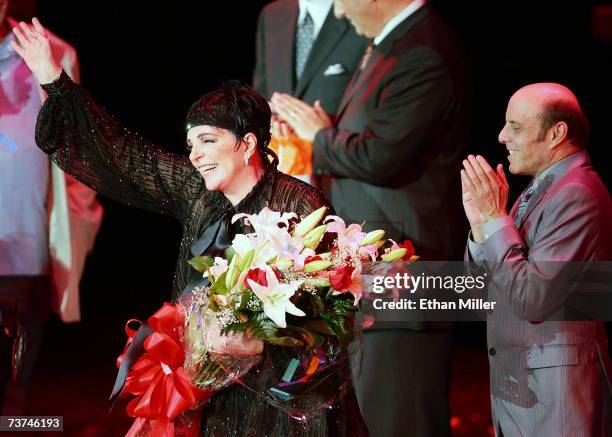 Entertainer Liza Minnelli waves to the crowd as her half-brother Joey Luft looks on after the first concert of Minnelli's three-night run at the...