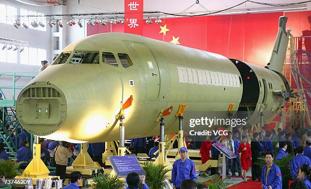 Workers assemble the ARJ-21 regional jet, China's first domestically produced commercial airplane, at the Shanghai Aircraft Manufacturing Factory...