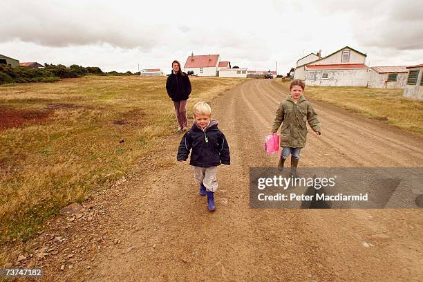 Stephen Dickson's partner Emma Reid walks with their children Adam and Logan to school at North Arm on February 7, 2007 in the Falkland Islands....