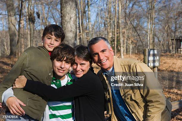 parents with children (8-14) in park, smiling, portrait - mammoth cave stock pictures, royalty-free photos & images