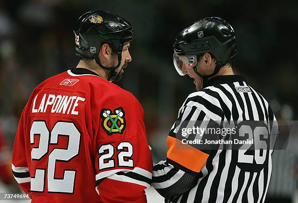 Martin Lapointe of the Chicago Blackhawks listens to NHL Referree Rob Martell during a break in NHL game action against the San Jose Sharks on March...