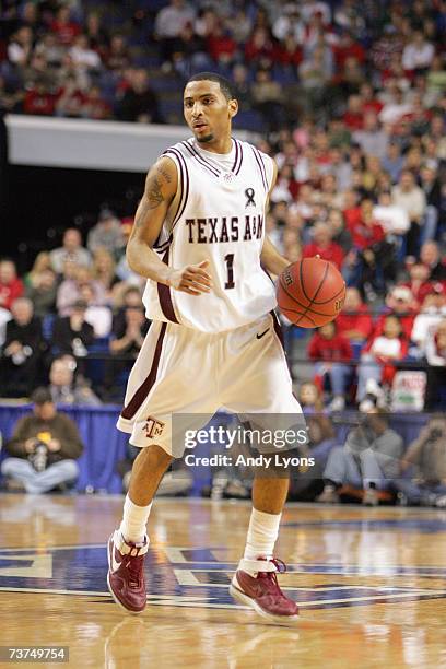 Acie Law of the Texas A&M Aggies dribbles the ball against the Louisville Cardinals during round two of the NCAA Men's Basketball Tournament at Rupp...