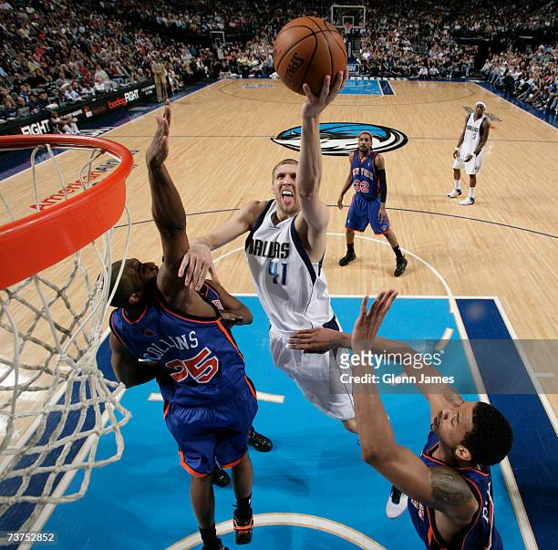 Dirk Nowitzki of the Dallas Mavericks lays it up against Erick Dampier of the New York Knicks on March 30, 2007 at the American Airlines Center in...
