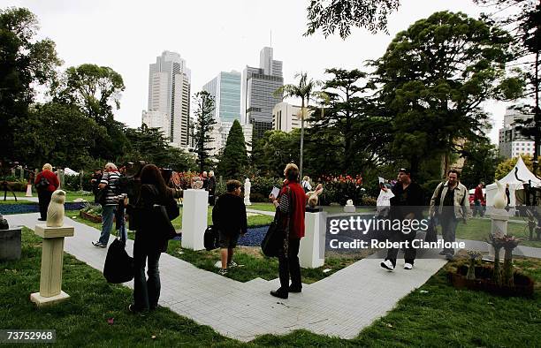 Visitors to the Flower and Garden Show admire some sculptures during the Melbourne International Flower and Garden Show at the Royal Exhibition...