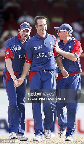 England's Paul Collingwood and Ian Bell congratulate Captain Michael Vaughan for the wicket of Ireland's Niall O'Brien, during the Super-Eight match...