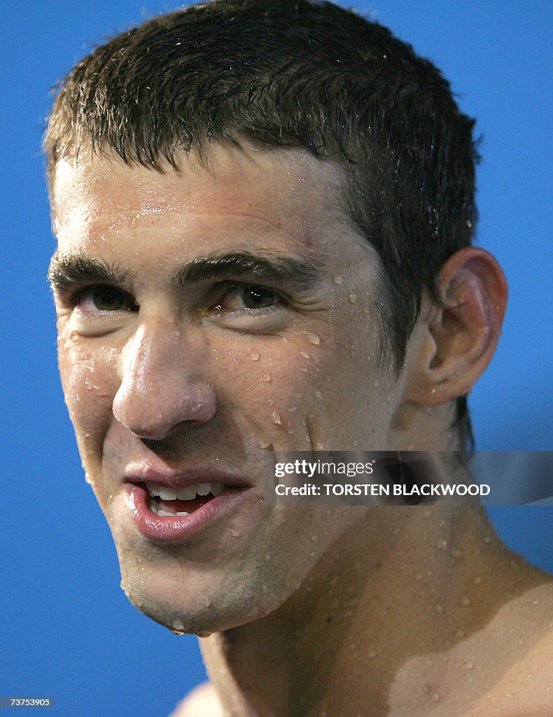 Michael Phelps of the US leaves the pool...