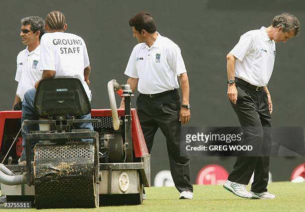 St John's, ANTIGUA AND BARBUDA: Umpires Aleem Dar , Billy Bowden and Asad Rauf check the condition of the outfield prior to the start of the World...