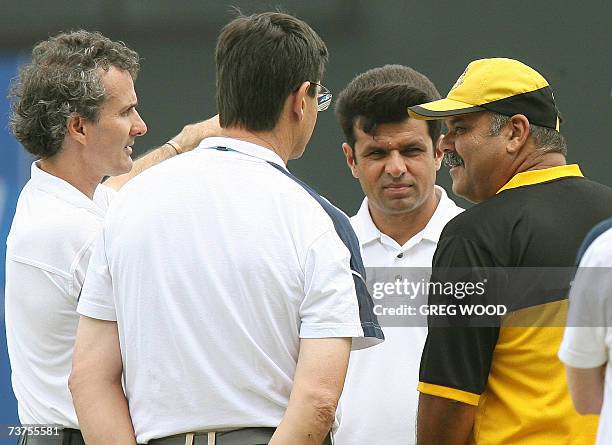 St John's, ANTIGUA AND BARBUDA: Umpires Aleem Dar and Billy Bowden speak with Bangladeshi coach Dav Whatmore on the condition of the outfield prior...