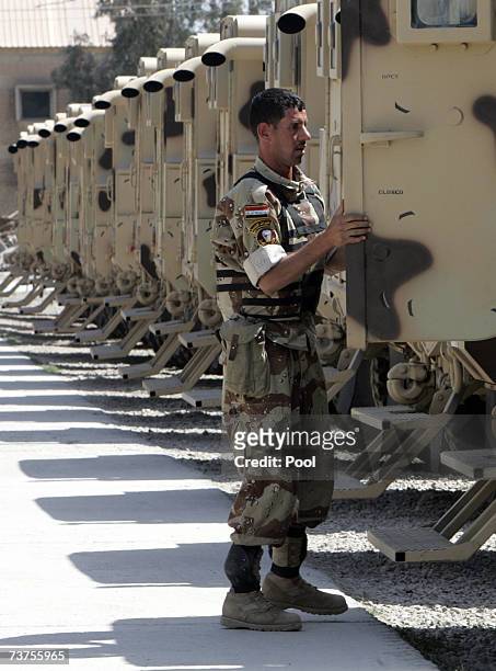 An Iraqi soldier looks at new Badger armored vehicles at Taji military base March 31, 2007 in Baghdad, Iraq. Soldiers from the 1st Battalion of the...