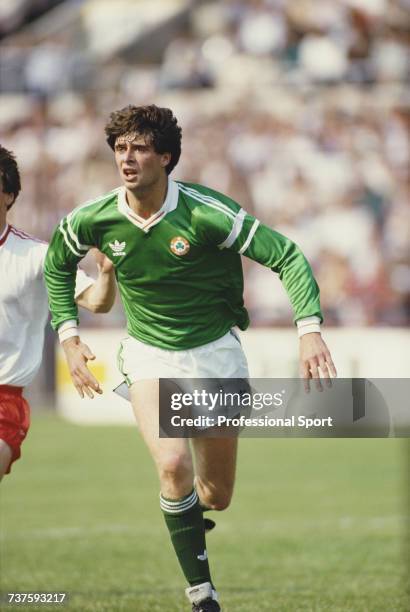 Irish professional footballer and forward with Arsenal, Niall Quinn pictured in action for the Republic of Ireland national football team during an...