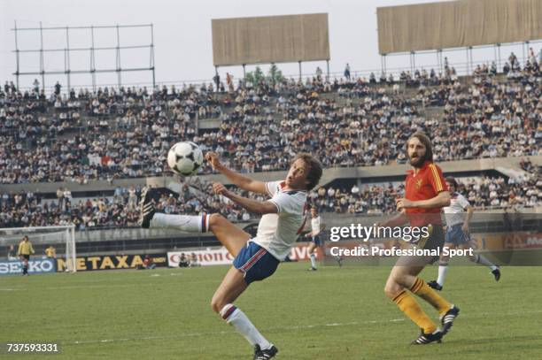 English professional footballer and defender with Liverpool, Phil Neal pictured with the ball as Luc Millecamps of Belgium looks on during the UEFA...