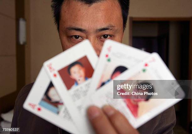 The "missing children playing cards" are displayed by Shen Hao, the founder of a missing person wetsite, the www.xrqs.com, on March 31, 2007 in...