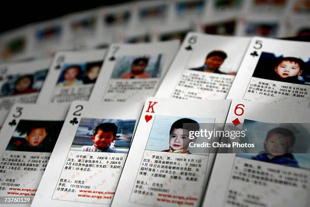 Playing cards showing details of missing children are displayed on March 31, 2007 in Beijing, China. The cards showing photographs and information of...