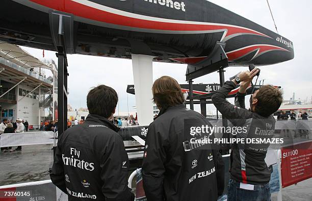 Members of the Emirates Team New Zealand challenger takes a picture of the Alinghi Swiss team defender during the unveiling day in the America's cup...