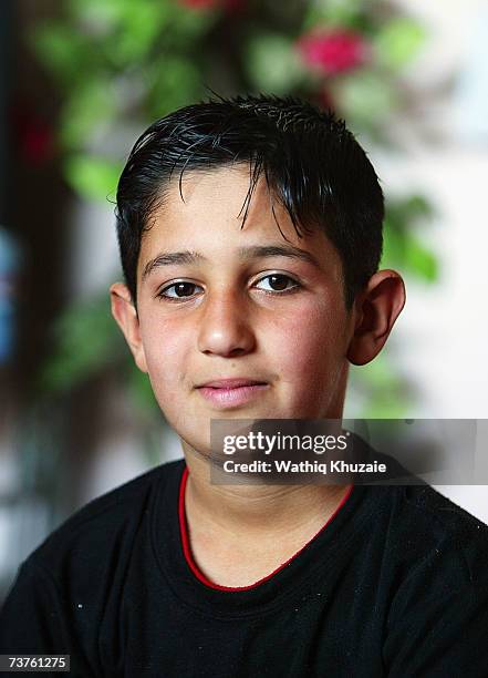 Ahmed, age 12 years, son of Fuad Mosa Muhammad looks on at his house on March 28, 2007 in Baghdad, Iraq. Fuad, a cook at a breakfast and lunch...