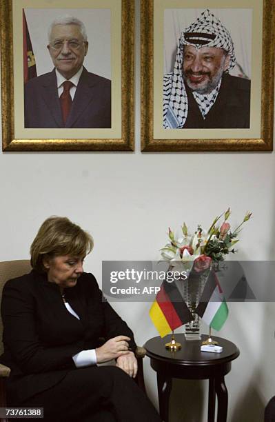 German Chancellor Angela Merkel pauses during a meeting with Palestinian president Mahmud Abbas at his headquarters in the West Bank city of...