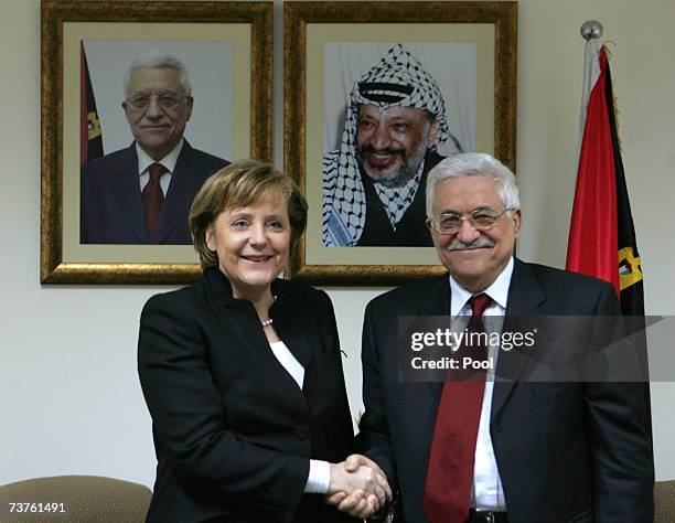German Chancellor Angela Merkel shakes hands with Palestinian President Mahmoud Abbas during their meeting at Abbas' headquarters April. 1, 2007 in...