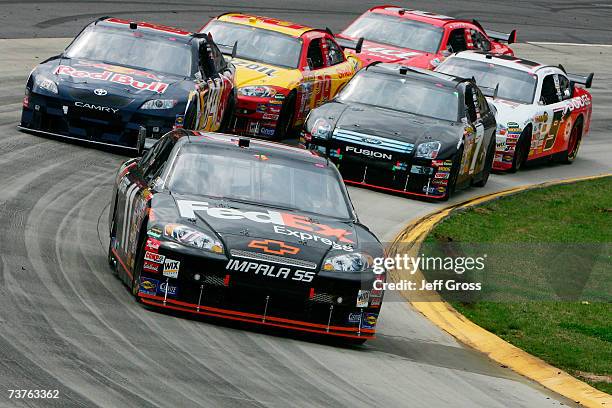 Denny Hamlin, driver of the FedEx Express Chevrolet, leads a group of cars, during the NASCAR Nextel Cup Series Goody's Cool Orange 500 at...