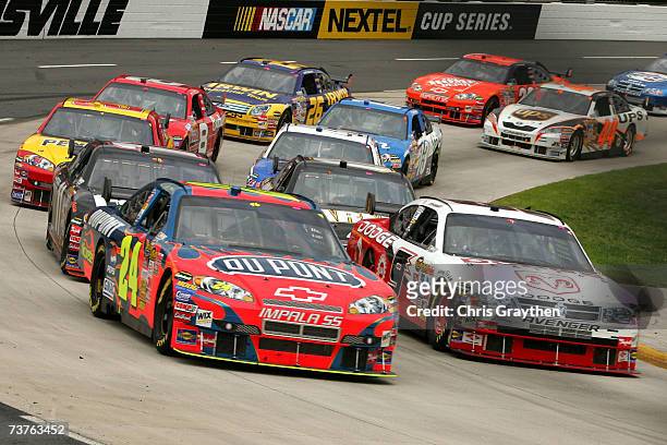 Jeff Gordon, driver of the DuPont Chevrolet, and Kasey Kahne, driver of the Dodge Dealers/UAW Dodge, lead others during the NASCAR Nextel Cup Series...