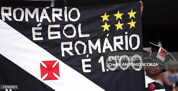 Supporter of Brazilian footballer Romario de Souza Faria holds a banner that pays tribute to the number 1000 goal of his carreer, 01 April 2007, as...