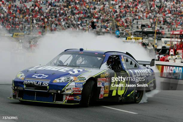 Jimmie Johnson, driver of the Lowe's Chevrolet, does a burnout after winning the NASCAR Nextel Cup Series Goody's Cool Orange 500 at Martinsville...