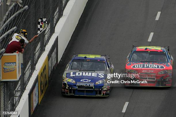 Jimmie Johnson, driver of the Lowe's Chevrolet, leads Jeff Gordon, driver of the DuPont Chevrolet, to the checkered flag to win the NASCAR Nextel Cup...