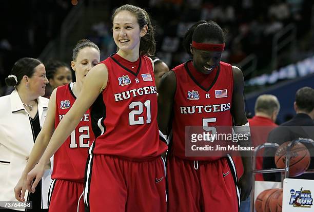Heather Zurich and Essence Carson of the Rutgers Scarlet Knights celebrate as they walk off the court after their 59-35 win against the LSU Lady...