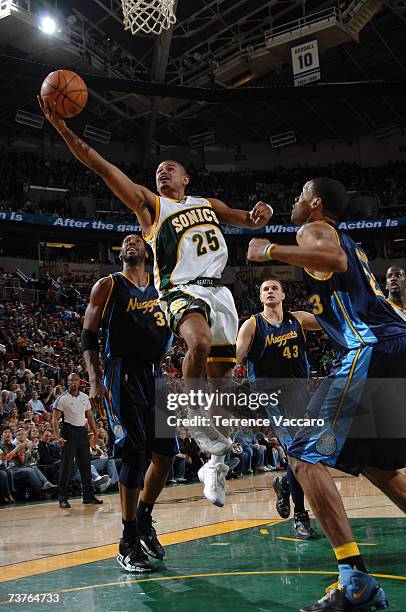 Earl Watson of the Seattle SuperSonics goes to the basket between the defense of Nene, Linas Kleiza and Marcus Camby of the Denver Nuggets on APRIL...