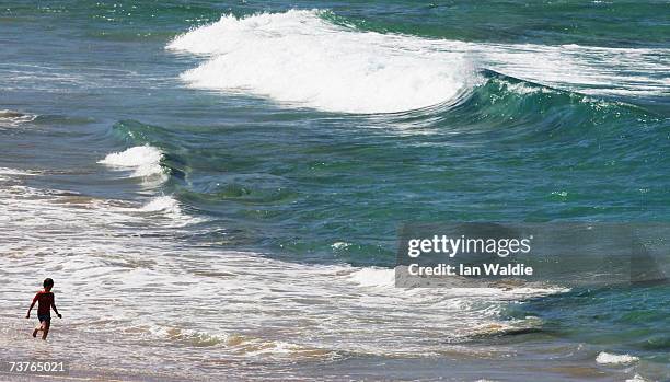 Boy enters the water at Bondi Beach despite the beach's closure following a tsunami warning on April 2, 2007 in Sydney, Australia. All of New South...