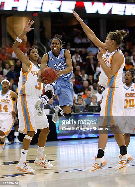 Alex Miller of the North Carolina Tar Heels drives for a shot attempt against Candace Parker and Sidney Spencer of the Tennessee Lady Volunteers...