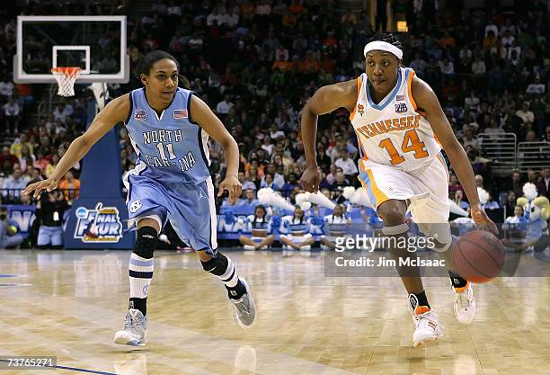 Alexis Hornbuckle of the Tennessee Lady Volunteers drives against Alex Miller of the North Carolina Tar Heels during their National Semifinal game of...