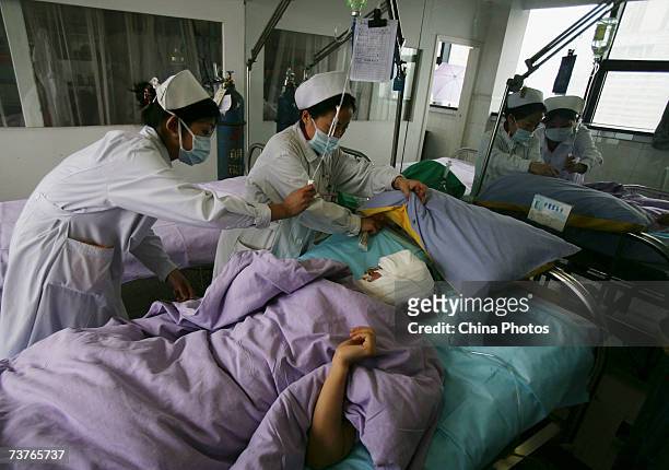 Chinese girl Li Yan, who suffers from face atrophy, lies on a bed after her second corrective surgery, at a hospital on April 2, 2007 in Chongqing...