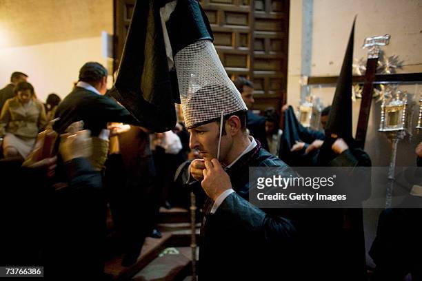 Members of 'La Borriquita' brotherhood prepares themselves in The Church of La Anunciacion prior the departure of the procession on April 1, 2007 in...