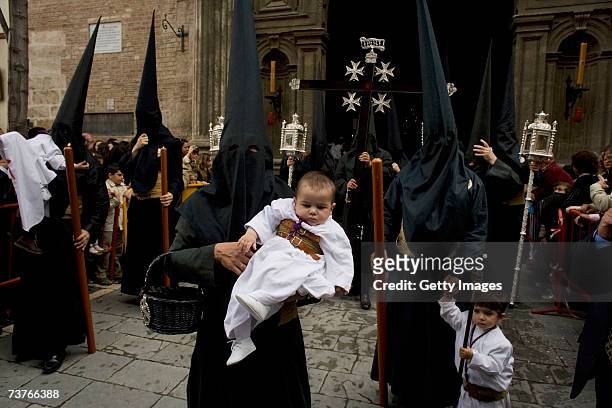 Members of 'La Borriquita' brotherhood leave the church of The Church of La Anunciacion as they walk in procession on April 1, 2007 in Seville,...