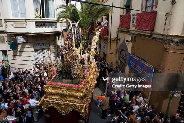 The carriages of 'La Borriquita' brotherhood depicting a sculpture of Jesus' triumphant entering into Jerusalem, riding a donkey and accompanied by...