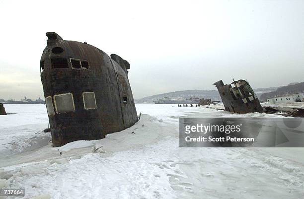 Abandoned Russian military submarines lay stuck in the ice where they sunk January 28, 2001 in Vladivostok, Russia. The country's military has...