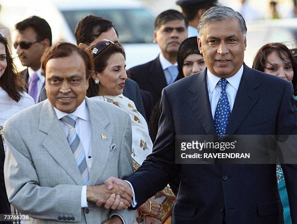 Pakistan Prime Minister Shaukat Aziz is welcomed by Indian Minister of Petroleum and Natural Gas Murali Deora upon his arrival at Indian Air Force...