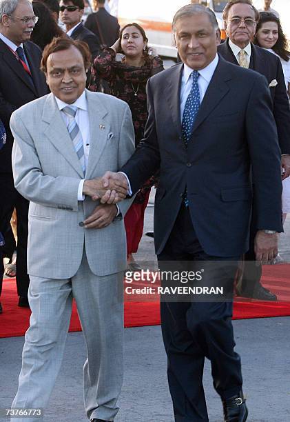 Indian Minister of Petroleum and Natural Gas Murali Deora shakes hands with Pakistan Prime Minister Shaukat Aziz upon his arrival at Indian Air Force...