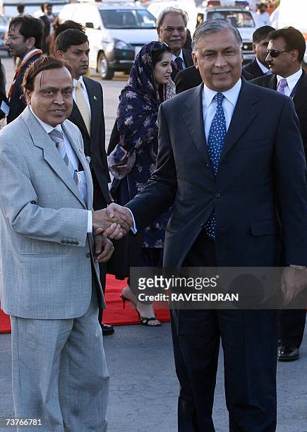 Indian Minister of Petroleum and Natural Gas Murali Deora shakes hands with Pakistan Prime Minister Shaukat Aziz upon his arrival at Indian Air Force...