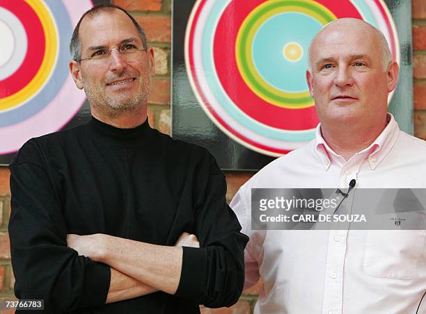 United Kingdom: Apple Chief Executive Officer Steve Jobs poses with Eric Nicoli , Chief Executive Officer of EMI, during a photocall at EMI's offices...