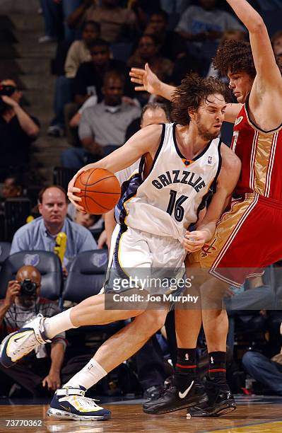 Pau Gasol of the Memphis Grizzlies drives against Anderson Varejao of the Cleveland Cavaliers at FedExForum on March 14, 2007 in Memphis, Tennessee....