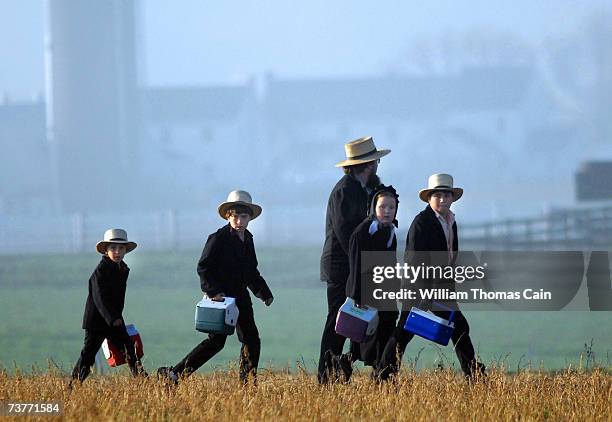 Amish children head to their newly built schoolhouse April 2, 2007 in Nickel Mines, Pennsylvania. The school opened six months from the day, October...