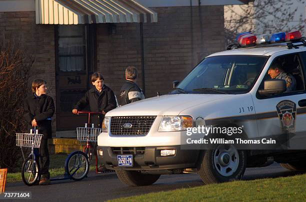 Amish children pass Pennsylvania State Troopers as they head to their newly built schoolhouse April 2, 2007 in Nickel Mines, Pennsylvania. The school...