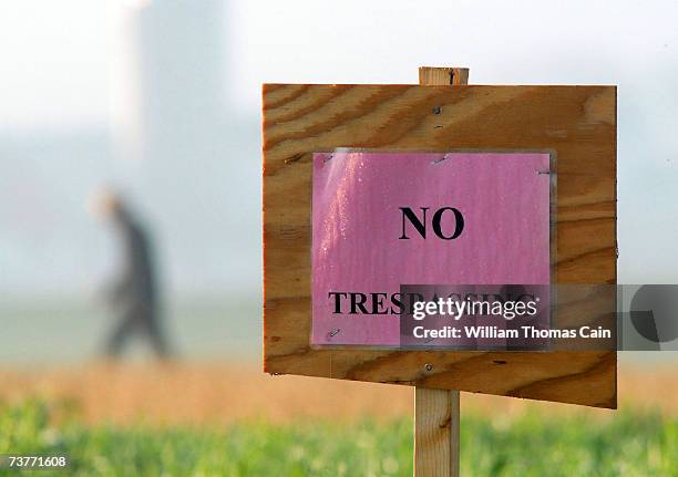 An Amish man walks away after posting "No Trespassing" signs on a field near a new schoolhouse April 2, 2007 in Nickel Mines, Pennsylvania. The...