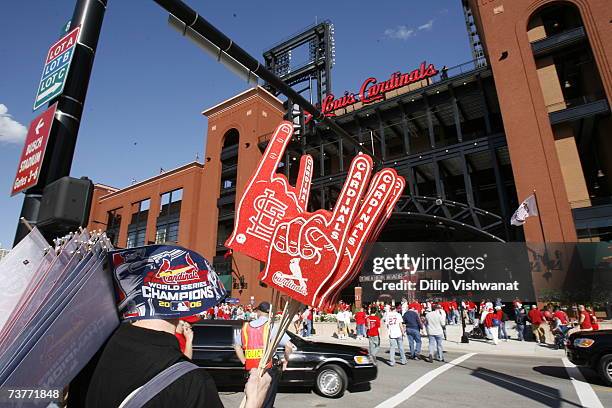 Vendor sells foam fingers and pennants outside Busch Stadium before the St. Louis Cardinals game against the New York Mets during their Opening Day...