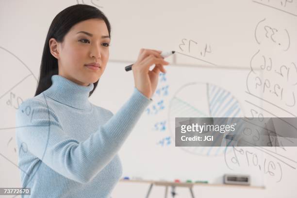 asian businesswoman writing on white board - mathematician stock pictures, royalty-free photos & images