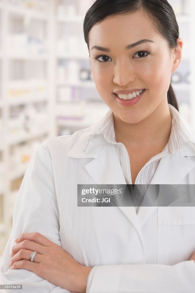 Asian female pharmacist standing in pharmacy