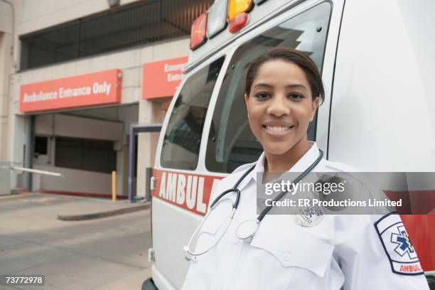 african female emt next to ambulance - emergency services occupation ストックフォトと画像