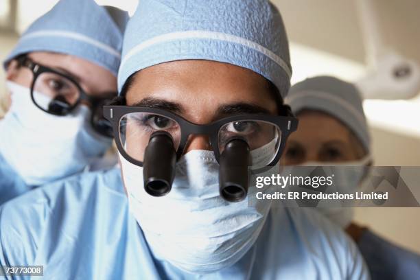 close up of surgeons with binocular loupes - surgical loupes stock pictures, royalty-free photos & images